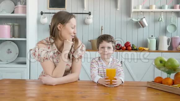 为快乐的美国家庭提供早餐妈妈和小男孩在厨房视频的预览图