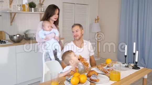 快乐的母亲父亲和儿子在家吃早餐视频的预览图