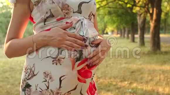 一个穿着衣服的怀孕女孩的腹部特写视频的预览图