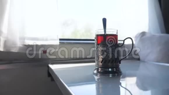 铁路旅行概念一杯玻璃杯中的勺子茶老式的茶摊在火车车厢的桌子上视频的预览图