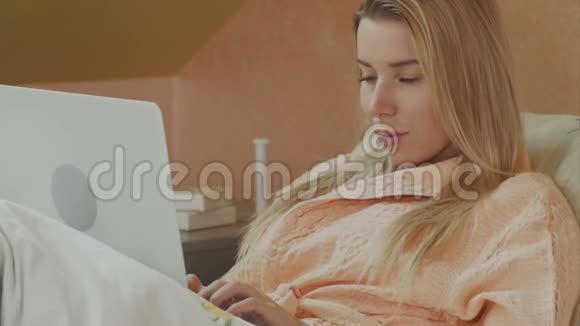 病人躺在病床上拿着笔记本电脑视频的预览图