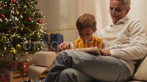 快乐的老人和他的孙子准备圣诞礼物视频的预览图