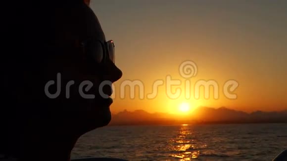 迷人的女人在日落时在游艇上放松视频的预览图