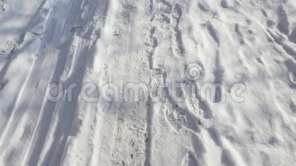 雪中的脚印和脚印雪中覆盖的城市街道视频的预览图