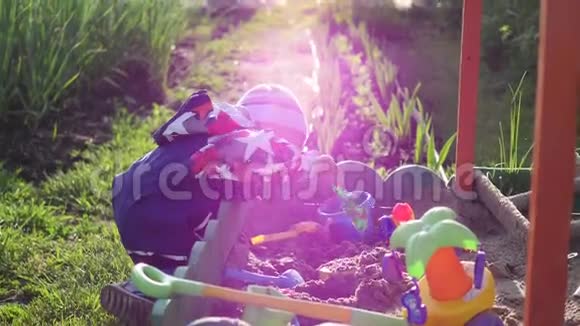 孩子玩沙箱里的玩具夏日阳光明媚户外娱乐和游戏视频的预览图