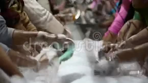 人们一起在Amritsar的公共厨房洗碗特写视频的预览图