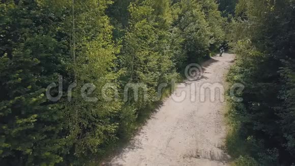 极端摩托车手在森林里的道路上骑着车莫托科罗斯莫托波特视频的预览图