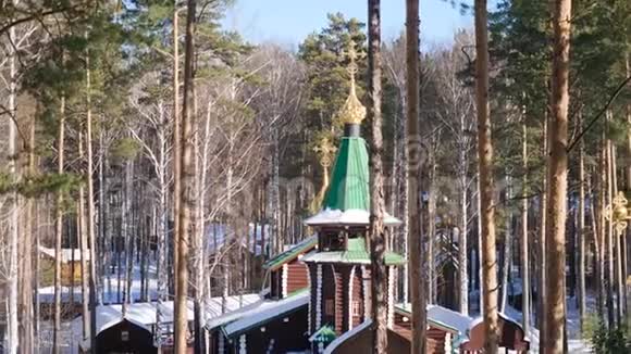 降雪后在基督教教堂的背景下用白雪覆盖的树木呈现冬季景观寒冷的晴天视频的预览图
