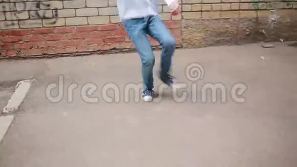 少年跳舞在砖墙的背景上跳舞视频的预览图