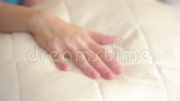 女性手按在枕头上柔软的枕头视频的预览图