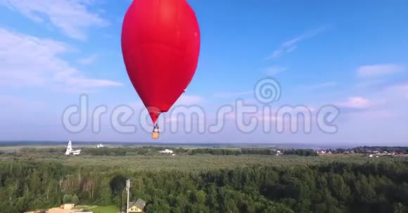 红色热气球在空气中呈心形四周看空中视频的预览图