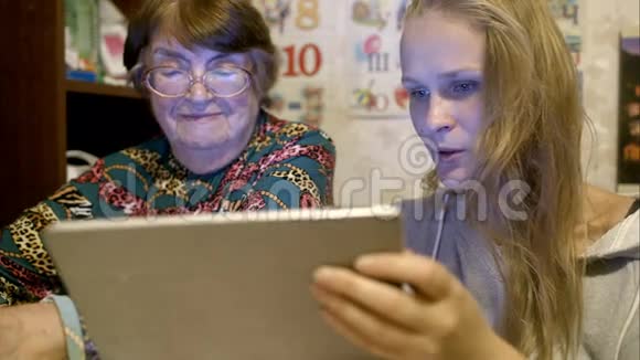 年轻和年长的女人看照片视频的预览图