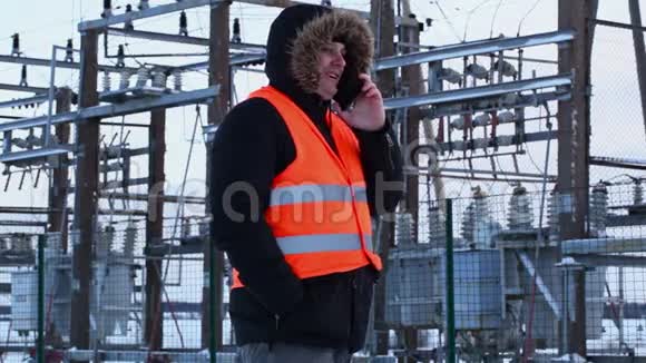 冬天在电厂里电工们用智能手机说话视频的预览图
