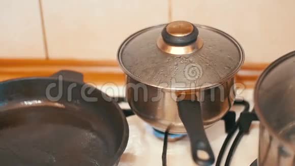 盖子远离蒸汽的压力在锅的食物在炉子的家庭厨房慢动作视频的预览图