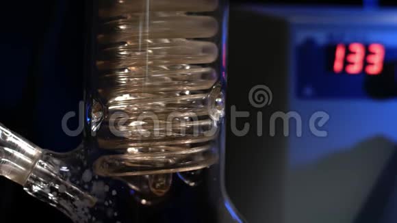 水晶螺旋螺旋玻璃管与水关闭玻璃螺旋管从回流冷凝器与自来水视频的预览图