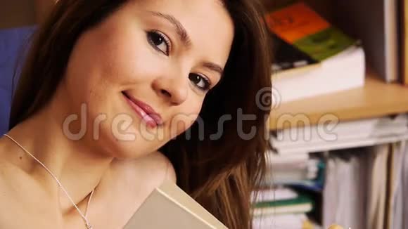 女孩微笑图书馆的书视频的预览图