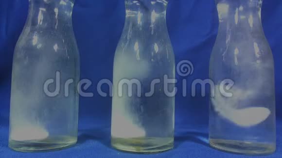 阿司匹林或泡腾药丸滴在蓝色背景的一杯水中视频的预览图