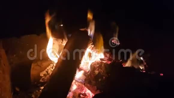 火里有烧焦的木头在黑暗中在明亮的火焰中燃烧木头视频的预览图