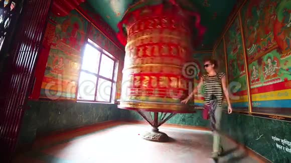 高加索旅游女孩在祈祷轮旋转视频的预览图