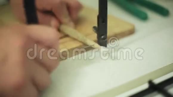 人用切奶酪刀在木制厨房板上切割鼓棒烹饪音乐视频的预览图
