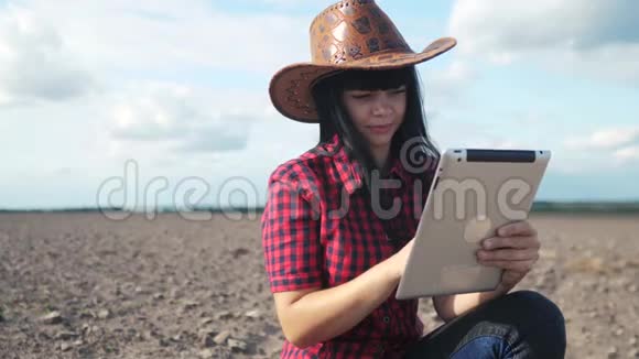 智慧生态是一种收获农业的耕作理念女农民用数字平板电脑研究地球生活方式的污垢视频的预览图