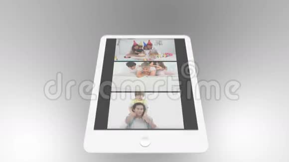 平板电脑被用来看两部家庭短片开始时滚动视频的预览图