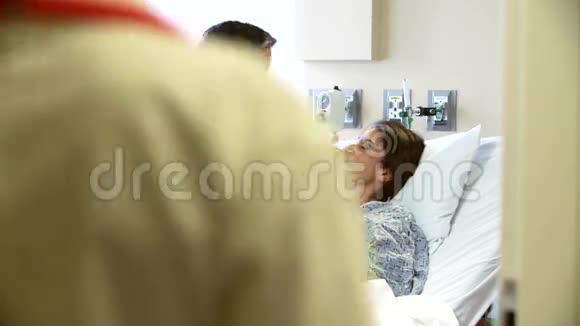 女医生在医院病房与丈夫和妻子交谈视频的预览图