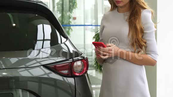 一名在汽车经销店使用智能手机的妇女被人砍伤视频的预览图