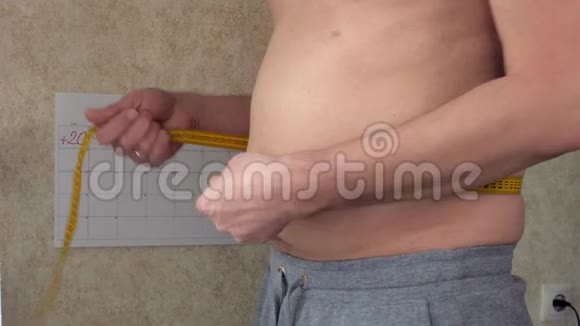 一个胖子测量他的腰一个大啤酒肚健康的生活方式视频的预览图