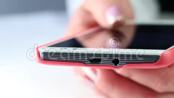 女人在手机上打短信用红色智能手机特写女性手视频的预览图