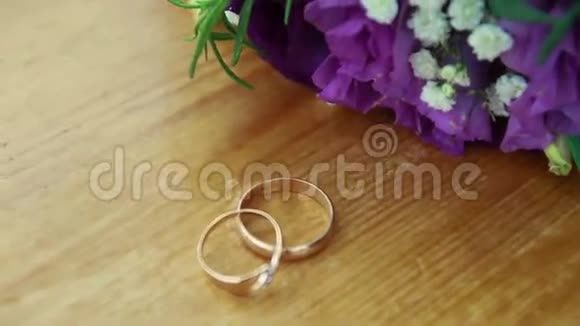 婚礼花束和跷跷板上的金戒指视频的预览图