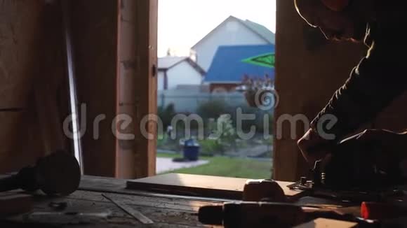 一个留着胡子的大胆的木匠圆锯切割木材背景太阳耀斑视频的预览图