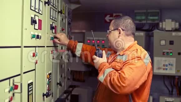 轮机工程师在发动机控制室进行无线电通讯视频的预览图