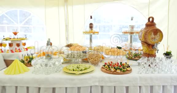 精美装饰的宴会桌上有不同的食品小吃和企业圣诞节生日开胃菜视频的预览图