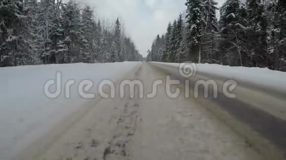 冬天在乡间小路上快速驾驶汽车背面视图视频的预览图