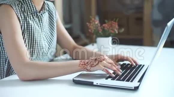 年轻女子用手提电脑戴智能手表视频的预览图