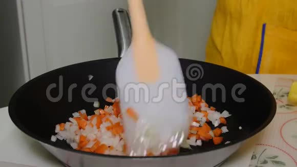 一个女人在锅里混合切碎的蔬菜视频的预览图