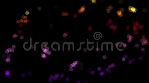 闪闪发光的彩色圆圈闪亮的粒子在黑色背景上闪闪发光模糊的小点闪烁无缝的循环视频的预览图
