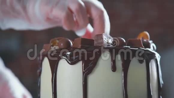 刚做的蛋糕糖果师旋转蛋糕并装饰它视频的预览图
