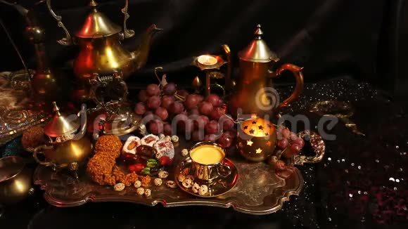 女性手与东方珠宝制作茶杯传统的摩洛哥糖果萨弗龙马萨拉奶茶杯视频的预览图