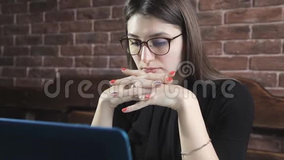 一位作家在笔记本电脑上靠砖墙写小说视频的预览图