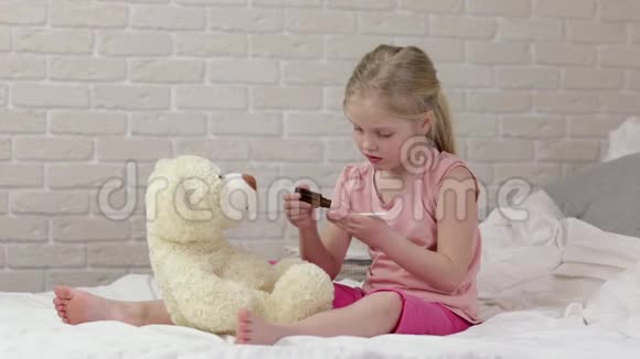 可爱的小女孩和泰迪熊玩医生视频的预览图
