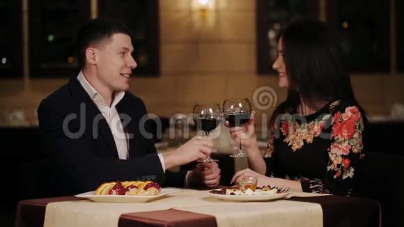 在餐馆吃午饭时一对微笑的夫妇碰着酒杯视频的预览图