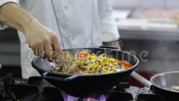 厨师在厨房的炒菜和肉视频的预览图