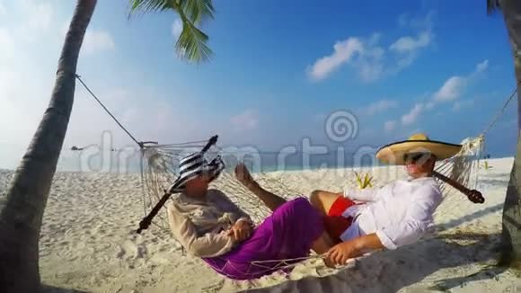 在海滩吊床放松浪漫的情侣视频的预览图