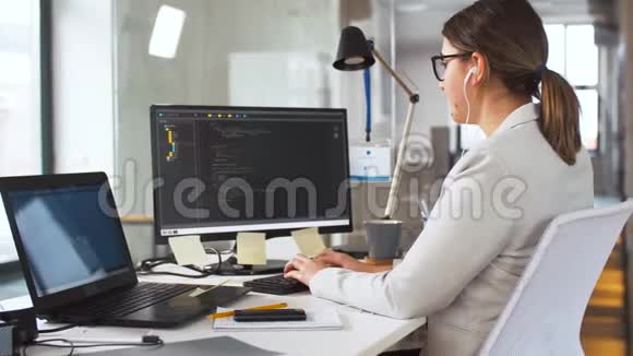 在电脑上工作的耳机中的程序员视频的预览图