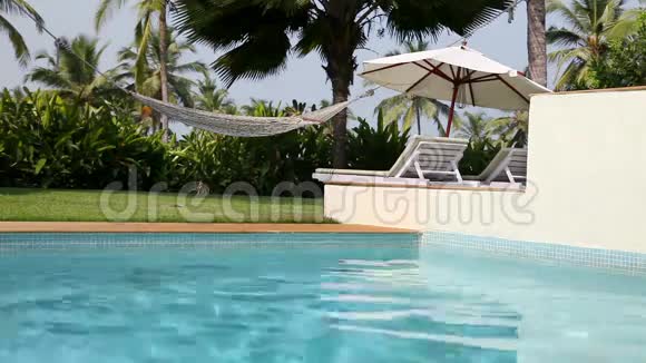 游泳池附近的空沙滩椅子视频的预览图