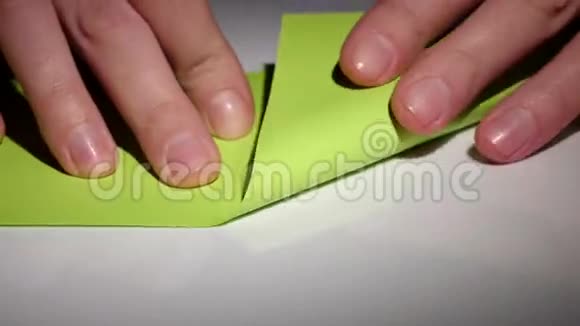 双手用绿色纸制作折纸特写视频的预览图