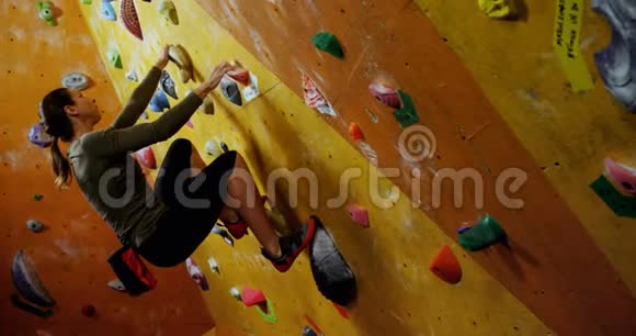 女子在巨石体育馆攀爬人造墙4k视频的预览图