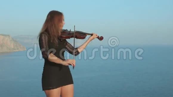 年轻的小提琴手在海边演奏灵感视频的预览图